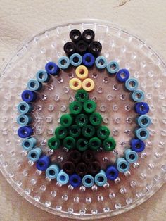 there is a plastic plate with buttons in the shape of a christmas tree