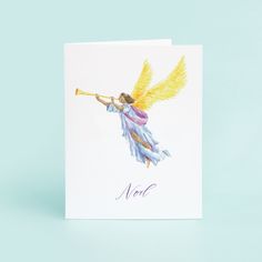 a card with an angel holding a trumpet