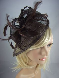 Large handmade sinamay fascinator with feather detail completes that special outfit. Whether you are a wedding guest, mother of the bride or wanting to stand out at a day at the races, this is the perfect accessory. The fascinator is mounted on a satin headband in a matching colour which makes it easy and comfortable to wear.  Measures approx 27cm or 16cm (excluding feathers). Please note fascinators are photographed displayed on a mannequin head which may be slightly smaller than an average adult head. This may result in the fascinator appearing slightly larger so please take note of the measurements before you purchase. Fitted Feather Fascinator For Wedding, Elegant Ostrich Feather Fascinator For Wedding, Feather Fascinator For Wedding And Royal Ascot, Feathered Fascinator For Wedding At Royal Ascot, Feathered Wedding Fascinator For Royal Ascot, Wedding Fascinator With Feather Trim For Royal Ascot, Fitted Ostrich Feather Fascinator For Kentucky Derby, Kentucky Derby Ostrich Feather Fascinator, Fitted Mini Hat With Feathers For Wedding