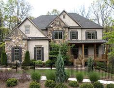 a large house with lots of windows in the front yard