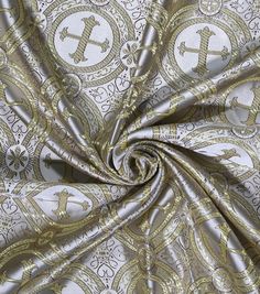 a gold and white fabric with an ornate design