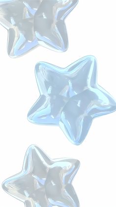 three shiny star shaped objects on a white background