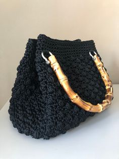 Handmade crochet bag in 100% polyester Swam Black cord. Leather base, bamboo handles and magnetic button closure. Width 27 cm Height 25 cm Color: black (different colors available). The bag is made to order and requires at least a week of preparation. Customizations may be requested both in terms of the material used and the dimensions. Due to the handcrafted nature of this item, dimensions may vary slightly. For further information contact me, I will be happy to answer you. Delicate Clothes, Handmade Crochet Bags, Bamboo Handles, Hand Crochet, Handmade Crochet, Crochet Bag, Handmade Natural, Purses And Handbags, The 100