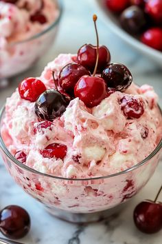 a bowl filled with ice cream and cherries