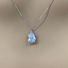 "The pendant pictured is a simulated diamond #6998 Also available with moissanite - please message us for pricing. -Approximate total carat weight: approx. 3.60ctw diamond equivalent -Center Stone Size: 12x8mm - approx. 3.60ct diamond equivalent -Center Stone Shape: pear / tear drop -Gem Type: simulated diamond -Stone Clarity: VVS1 -Stone Color: D -Moh's Scale: 8.5 hardness -Metal Type and Purity: 14k white gold -Setting: 5 prong basket head -Chain: delicate 14k gold chain / heavier option with Formal Diamond Solitaire Necklace With Teardrop Pendant, Formal Teardrop Pendant Solitaire Necklace In Fine Jewelry Style, Vvs Clarity Pear-shaped Diamond Necklace For Wedding, Formal Fine Jewelry Teardrop Pendant Solitaire Necklace, Formal Teardrop Pendant Solitaire Necklace, Pear-shaped Diamond Necklace With Vvs Clarity For Wedding, Formal Pear-shaped Cubic Zirconia Necklaces, Formal Cubic Zirconia Pear-shaped Necklace, Dazzling Pear-shaped Necklace For Anniversary