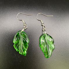 Celebrate your love of nature with a pair of these cute pressed-glass leaf earrings. Paired with silver-toned findings - but if you would prefer gold-toned accessories, message me after ordering and I'll switch them out.  These charms were purchased from a small business. #ShopSmall A donation will be made to the Eastern Pennsylvania Coalition for Abandoned Mine Reclamation (EPCAMR) for every purchase. Visit epcamr.org for more information. Green Leaf-shaped Earrings As A Gift, Green Leaf-shaped Jewelry With Matching Earrings, Green Leaf-shaped Earrings For Gift, Green Leaf-shaped Earrings For Pierced Ears, Handmade Green Leaf-shaped Jewelry, Cheap Green Leaf-shaped Earrings, Czech Glass Leaf Earrings, Nickel-free Green Leaf-shaped Jewelry, Hypoallergenic Leaf-shaped Earrings