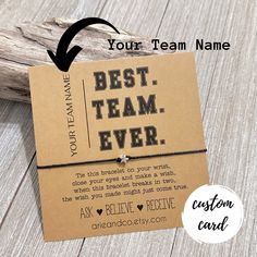 the best team ever card is on top of a piece of wood with an arrow