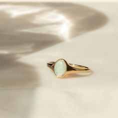 Meet your new favorite statement ring - the Opal Signet Ring. With just the right amount of sparkle and flash, this Australian opal ring makes a gorgeous statement by itself - or paired with your favorite stacked rings. It's made of 14k solid gold, so it'll last many lifetimes. After you're done with it, you can pass it on as an heirloom! DETAILS 14k solid gold ring 5mm x 7mm Australian opal Available in sizes 5-8 Weight: 1.5g Safe for sensitive skin & shower safe Matching jewelry: Oval Opal Nec Opal Ring Simple, Stacked Rings, Ring Stacks, Australian Opal Ring, Wax Ring, Opal Ring Gold, 2024 Style, Matching Jewelry, Jewelry Lookbook