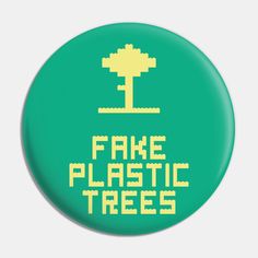 a green button with the words fake plastic trees in yellow and white letters on it