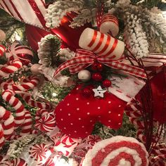 a christmas tree decorated with red and white candy canes, candies and ornaments