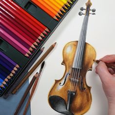 a drawing of a violin with colored pencils next to it