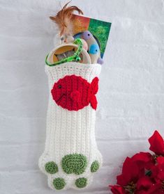 a crocheted christmas stocking with toys in it