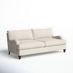 a white couch sitting on top of a white floor