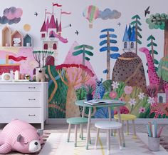 a child's room decorated with colorful wallpaper and furniture, including a large mural