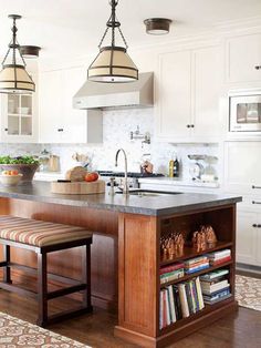 a kitchen with an island and two pendant lights