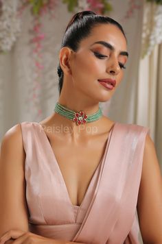 The red and mint Kundan choker necklace is inspired by the rich Indian jewelry-making techniques handcrafted by the artisans to celebrate the amalgamation of craftsmanship and modern design. The ruby-red choker is a most elegant and perfectly crafted choker to bejewel your neckline with shimmering Kundan that will create a style statement wherever you go. Pair this gorgeous replica of Bollywood jewelry with your ethnic or contemporary ensembles and create a look to remember. An ode to the beauti Reception Tilla Choker, Party Meenakari Temple Jewelry Choker, Party Temple Jewelry Meenakari Choker, Party Temple Jewelry Choker With Meenakari, Festive Temple Jewelry Choker For Parties, Temple Jewelry Choker For Diwali Party, Party Meenakari Choker, Green Kundan Choker Necklace, Green Cutdana Choker Necklace