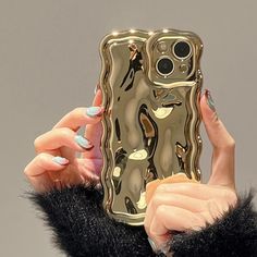 a woman is holding up her phone case to take a selfie with her fingernails