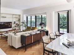 a living room filled with furniture and a flat screen tv