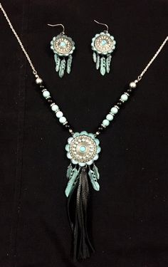 Western Silver & Turquoise Concho Necklace with Tassel and Matching Earrings Beautifully arranged antique silver concho pendant with feathers and black tassel on a chain with black, copper and turquoise beads. Matching earrings with feathers also. Concho measures 1-1/2" in diameter. Earrings measure 1" in diameter. Nickel & Lead Safe Earrings With Feathers, Concho Necklace, Copper And Turquoise, Western Rings, Western Bracelets, Western Purses, Western Belt Buckles, Western Earrings, Horse Jewelry