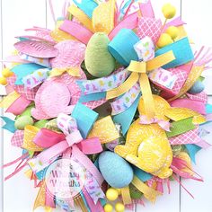 a colorful wreath with easter eggs and ribbons