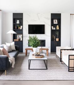 a living room filled with furniture and a flat screen tv mounted on the wall above a fireplace