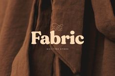 the fabric is brown and has white lettering that reads,'the fabric quilting store '