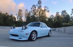 a blue sports car parked in a parking lot