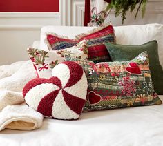 pillows and christmas decorations on a bed