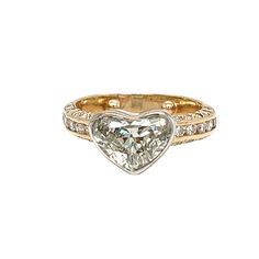 a gold ring with a heart shaped diamond in the center and two rows of diamonds around it