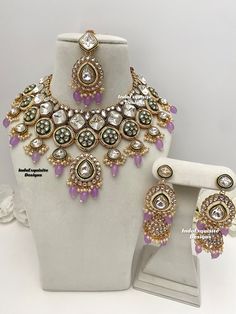 Premium quality Kundan Necklace comes with elegant Jhumki Earrings and Tikka/ Indian Jewelry/Premium Quality Polki and Kundan Jewelry/lavendar     All items are shipped from Brampton, Ontario, Canada. If you need your item by a certain day, please reach out to us for express delivery option before placing the order so that we can update the shipping for you. Standard shipping/delivery timeline Below are the delivery timeline estimates. We dispatch all orders by the next business day. ---> USA de Festive Bollywood Purple Jewelry, Festive Purple Bollywood Jewelry, Purple Kundan Jewelry For Diwali, Purple Kundan Earrings For Wedding, Purple Jewelry For Wedding On Diwali, Purple Jewelry For Wedding And Diwali, Festive Purple Necklace For Wedding, Purple Kundan Bollywood Jewelry, Purple Kundan Jewelry Gift