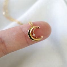 "Beautiful and lovely gold crescent moon necklace made of tiny cubic stone gold crescent moon with skinny gold plated brass chain. Soft and warm looking necklace is good for yourself or gift ! Your necklace will ship in a rudiana gift box. ♥Length 15\" - 20\" ♥Pendent 1/2\" x 1/2\" ♥Gold plated over brass / Cubic Zirconia ♥ Delivery Time Fast shipping within 1 - 3 days ♥ See more Rudiana Accessories Rudiana.etsy.com" Gold Chain With Moon Pendant, Gold Moon Necklace For Wedding, Delicate Gold Moon Jewelry, Gold Crescent Charm Necklace With Delicate Chain, Gold Crescent Charm Necklace For Gift, Everyday Gold Crescent Charm Necklace, Dainty Yellow Gold Crescent Charm Necklaces, Gold Plated Crescent Charm Necklaces, Dainty Crescent Yellow Gold Charm Necklaces