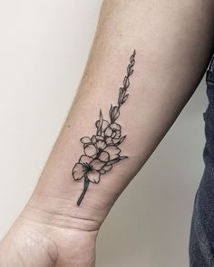 a black and white flower tattoo on the wrist