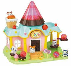 a small toy house with lots of animals around it and an ice cream cone on top