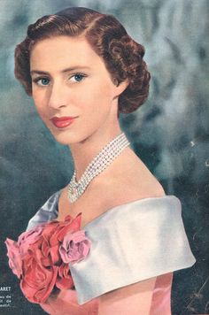 an old photo of a woman wearing a tiara and holding a rose in her hand