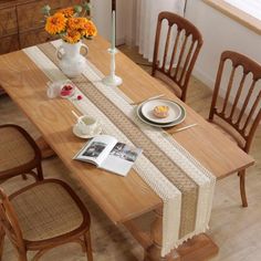 the table is set with plates, cups and flowers in vases on top of it