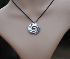 Hand crafted New Zealand Maori koru in Solid .925 sterling silver. Finished by hand to a high polish with traditional Maori engraved detail and hung on a black adjustable cord. The Maori koru design is a treasured symbol in New Zealand that represents nature . It brings personal growth and renewal of the spirit (Wairua) with inspiration for new ideas & adventures. We have added a sculptural wave design to bring energy & vitality and connections with the ocean. Unique New Zealand designs Maori Earrings, Maori Koru, Maori Pendant, Silver Ocean-inspired Pendant Jewelry, New Zealand Jewellery, Adjustable Knot, Wave Design, Washer Necklace, Silver Fashion