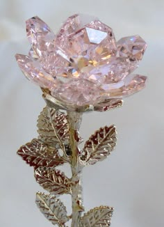 Express your feelings with this elegant pink crystal rose that sparkles in the light. The rose stands approximately 4 1/2 inches tall. The rosebud, which is approximately 1 1/2 inches in diameter, is handcrafted by the artisans at Bjcrystalgifts using Swarovski Crystals. A silvertone heart hangs from the silvertone rose stem. The artisans at Bjcrystalgifts will personalize your rose by hand stamping two initials of your choice on the metal heart. The rose comes packaged in a box that is suitable for giftwrapping Fiori Frangipani, Rose Belle, Crystal Aesthetic, Magical Jewelry, Crystal Figurines, Crystal Rose, Metal Heart, Fantasy Jewelry, Crystal Flower