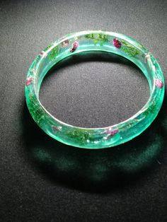 Resin bangle with real dried flowers and evergreen sprigs encapsulated Handmade Clear Bracelets As Gifts, Handmade Clear Bracelets As A Gift, Handmade Clear Bracelets For Gifts, Resin Bangle Jewelry Gift, Resin Bangle Jewelry For Gifts, Adjustable Bracelets With Pressed Flowers, Adjustable Round Bracelets With Pressed Flowers, Adjustable Resin Bangle Jewelry, Clear Bangle Bracelet As A Gift