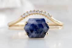 A modest statement ring designed by Alexis Russell, featuring a raw Montana sapphire. This ring adds a beautiful pop of color and offers you a modern aesthetic to up your ring stack. Alexis Russell Jewelry, Raw Sapphire Ring, Alexis Russell, Raw Sapphire, Hexagon Ring, Custom Diamond Rings, Montana Sapphire Ring, Handcrafted Engagement Ring, Deep Blue Color