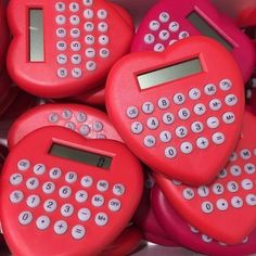 several heart shaped calculators are arranged in a box with the numbers on them