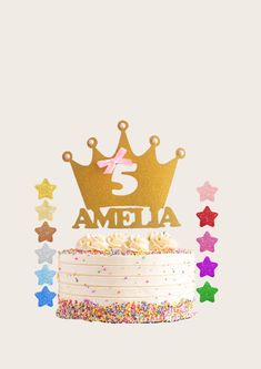 a birthday cake with sprinkles and a gold crown on top, surrounded by stars