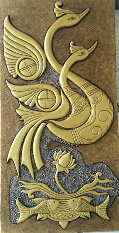 a gold and black tile with a bird on it's face, in the shape of a dragon