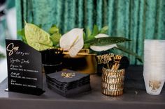 a table topped with lots of black and gold items