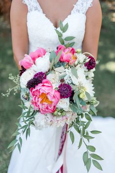 a bridal holding a bouquet of pink and white flowers