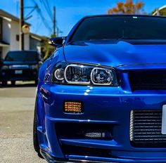 the front end of a blue sports car