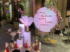 there are many items on display at this wedding reception and it is decorated with flowers, feathers and candles