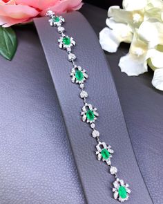 A DREAM COMES TRUE! Gorgeous masterpiece! ONE OF A KIND Bracelet! Featuring 6 pieces of extra fine GLOWING BRIGHT GREEN Zambian Emerald weighting a total of 4.05 carats... and OVER 138 pieces of SPARKLING, top-grade, F/VS Diamonds (2.28 carat in total). SET IN ONE-OF-A-KIND 18K Solid White Gold, meticulously designed and handcrafted BRACELET! A true heirloom piece that can transcend beyond times and eras.... EMERALDS: Weight: 6 pieces 4.05 carats (about 0.7 carat each) Shape: OVAL CUT Dimensions Luxury Silver Tennis Bracelet With Emeralds, Elegant Silver Tennis Bracelet With Emeralds, Elegant Silver Emerald Tennis Bracelet, Emerald White Gold Bracelet, Silver Emerald Tennis Bracelet For Formal Occasions, Formal Silver Tennis Bracelet With Emeralds, Formal Silver Emerald Tennis Bracelet, Formal Silver Diamond Bracelet With Emeralds, Silver Emerald Bracelet Fine Jewelry