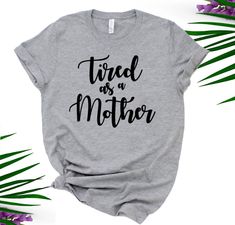 "Tired as a Mother Unisex Tee  The perfect shirt that's guaranteed to get some giggles!  If you prefer this design on a different style t-shirt, let me know and we can custom order for you.  Can do Unisex V-Neck, Fitted Ladies style, Tanks Tops, Long Sleeve, etc... HOW TO ORDER: 1.  Use the drop down menu to select the color and size of your top 2.  Include the following information in the 'Note to Seller' box at checkout:      -Font Color {Color chart in photos} ITEM DETAILS: UNISEX fit (for la Funny Print Shirt With Relaxed Fit As Gift, Relaxed Fit Shirt With Funny Print For Gift, Relaxed Fit Shirt With Funny Print As Gift, Funny Relaxed Fit Shirt With Text Print, Funny Text Print Shirt With Relaxed Fit, Funny Text Print Relaxed Shirt, Relaxed Fit Pre-shrunk Shirt For Mother's Day, Funny Graphic Print Shirt For Mother's Day, Relaxed Fit Graphic Tee With Funny Text