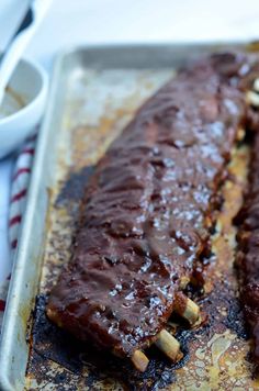 two ribs covered in sauce and nuts on a baking sheet