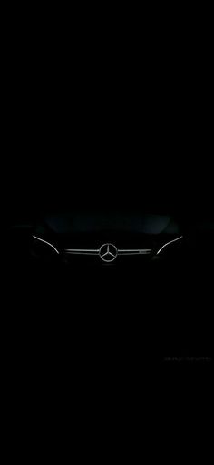 the mercedes logo is shown in the dark